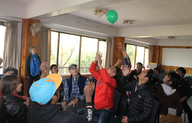Nepali students and mentors playing balloon game