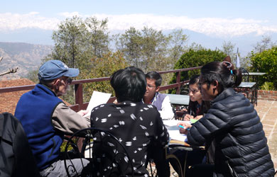 Nepali students with mentors studying on patio deck
